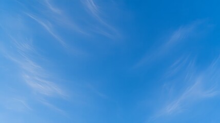 Obraz premium Bottom view straight up at vast deep blue sky with thin wispy cirrus clouds