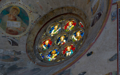Rose window in the Duomo di Orvieto, Italy, featuring intricate Gothic stained-glass patterns and...