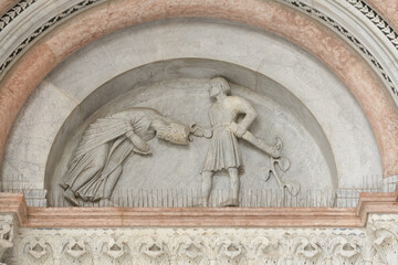 Romanesque marble lunette depicting the martyrdom of Saint Regulus above a portal of San Martino...
