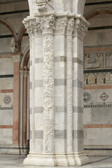 Sculpted capital and column with lion and biblical figures at the portal of San Martino Cathedral...