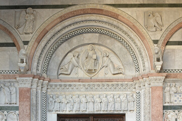 Main portal of San Martino Cathedral in Lucca, Italy, with Romanesque reliefs, polychrome marble...