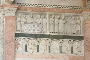 Relief frieze on the facade of San Martino Cathedral, Lucca, Italy, depicting scenes from the life...