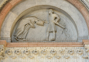 Romanesque marble lunette depicting the martyrdom of Saint Regulus above a portal of San Martino...