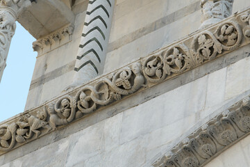 Romanesque frieze with vine scrolls and hybrid creatures on the facade of San Martino Cathedral,...