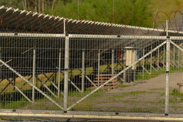 A barbed wire fence effectively surrounds and encloses a designated fencedin area, ensuring added...