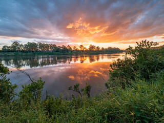 Beautiful Sunset Over The River with Cloud Reflections