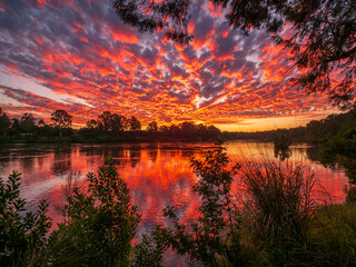 Beautiful Sunset Over The River with Cloud Reflections