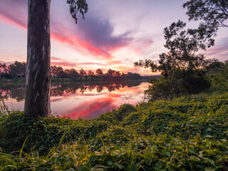 Beautiful Sunset Over The River with Cloud Reflections