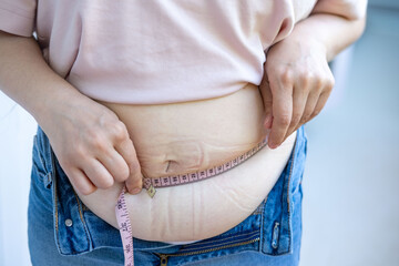 Fat belly in jeans, Chubby woman checking waistline, self check, real life, midlife crisis, home...