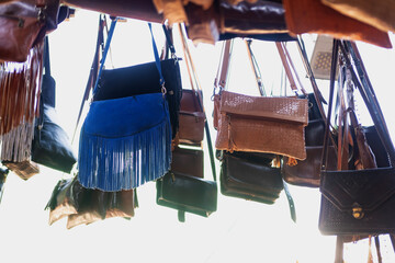 Colorful Vibrant leather handmade Moroccan bags, goods for sale in traditional local souk, story...