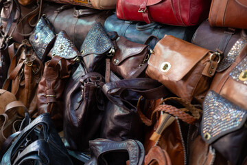 Colorful Vibrant leather handmade Moroccan bags, goods for sale in traditional local souk, story...