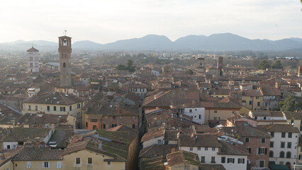 View from Torre delle Ore of Via Fillungo in Lucca, Italy, showing rooftops, medieval towers and...