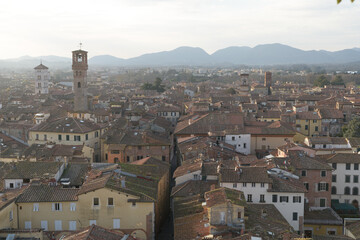 View from Torre delle Ore of Via Fillungo in Lucca, Italy, showing rooftops, medieval towers and...