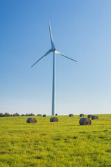 Straw bales in f ront of windmills in Czech Republic