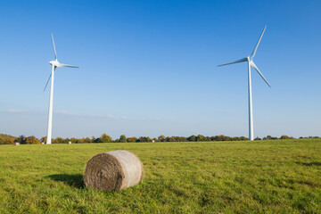 Straw bales in f ront of windmills in Czech Republic