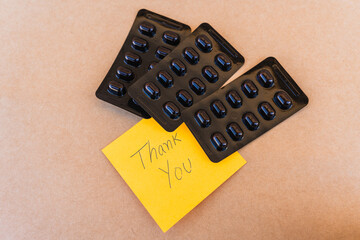 Thank you note that says thank you handwritten with blue pen with a background of an oximeter and...