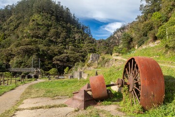 Hikers explore the Karangahake Gorge Historic Walkway and The Crown Mines in New Zealand. The area...