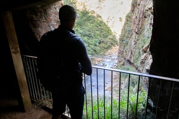 A hiker pauses at a lookout point in The Crown Mines, Karangahake, Coromandel Peninsula, New...