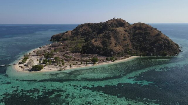 Aerial landscape view of Kanawa Island beach with long bridge dock surrounded by turquoise ocean.