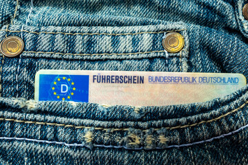 German driver's license in jeans pocket with EU flag visible, Modern European driving permit, transport rights, EU citizen travel, Germany mobility document, close-up macro shot