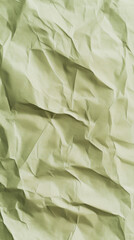 Close-up of crumpled green paper background with textured folds 