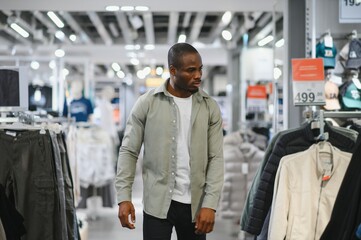 Customer choosing clothes in fashion store