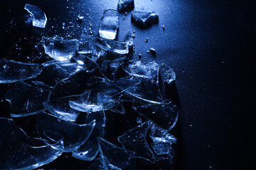 Broken Glass Shards on Dark Surface with Cold Lighting