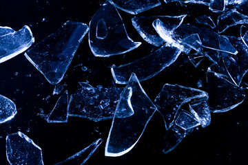 Broken Glass Shards on Dark Surface with Cold Lighting