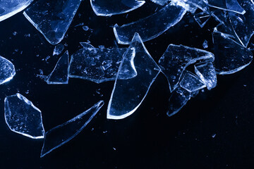 Broken Glass Shards on Dark Surface with Cold Lighting