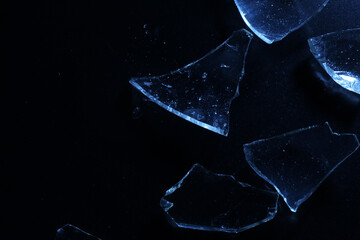Broken Glass Shards on Dark Surface with Cold Lighting