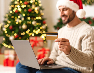  Man shopping online festive season while protecting credit card details with hand