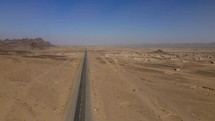 Aerial view of arid desert with winding road, Pakistan.