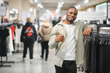 Stylish man shopping for clothes at mall