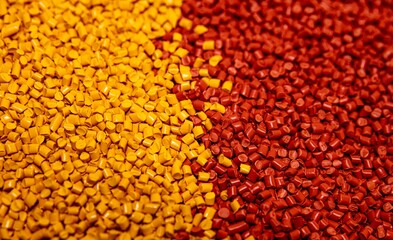 Yellow and red plastic polymer granules