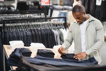 Man shopping for stylish clothing in mall
