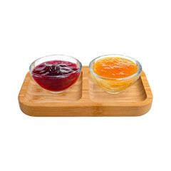 Two round clear glass bowls with cherry and apricot jams on a wooden tray, perfect for gourmet breakfasts, food styling, and elegant buffet presentations