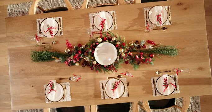Christmas, celebration and table setting with decorations in home for holiday event, cutlery or party. Above, thanksgiving and xmas arrangement in dining room with tableware, dinner or festive season