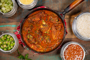 tipical brazilian recipe with farm chicken, gravy, rice and okra ( galinha caipira ). top view