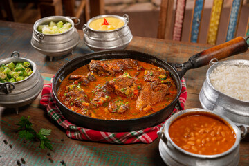 tipical brazilian recipe with farm chicken, gravy, rice and okra ( galinha caipira ).