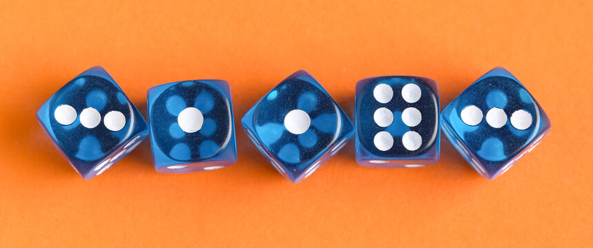 Blue dices on orange background, top view