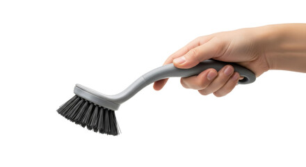 A hand holding a gray dish brush with black bristles against a black and white background space brush
