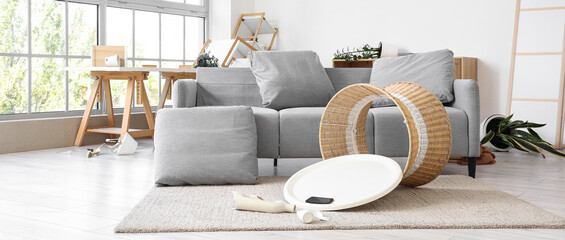 Interior of messy living room with sofa and overturned table after earthquake