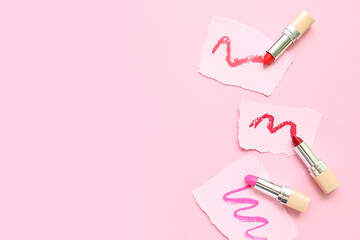 Lipsticks and papers with strokes on pink background
