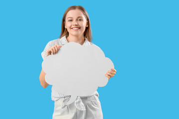 Happy young woman with blank speech bubble on blue background