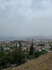 Fototapeta premium View of a coastal town from a hilltop on a cloudy day