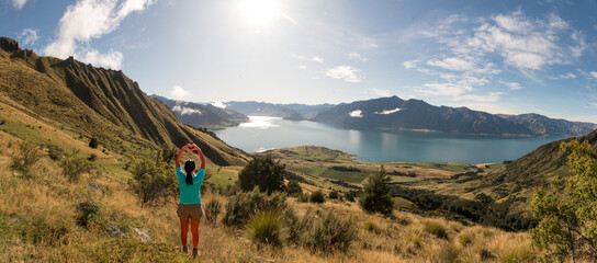 Rear view of hiker enjoying the  views of lake Hawea from the Isthmus track walkway