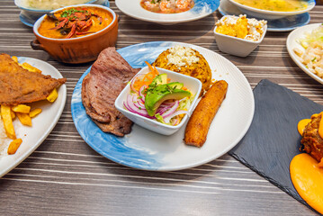 Recipe for Moro rice with beef steak, fried plantain, and avocado salad on a porcelain plate