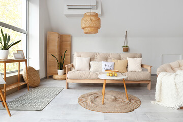 Obraz premium Interior of light living room with white sofa, armchair and coffee table