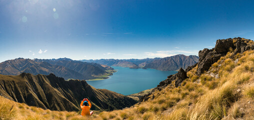 Rear view of hiker enjoying the  views of lake Hawea from the Isthmus track walkway