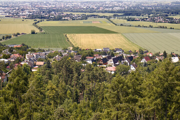 Aerial view of forest, village and meadows. View from the top of the landscape with forest, village and fields. Nature of the Czech Republic